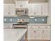 Kitchen boasts stainless steel appliances, quartz counters, and white shaker cabinets at 1302 Gardenia Ct, Villa Rica, GA 30180