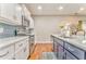 Bright kitchen with stainless steel appliances, white cabinets, and backsplash tile at 1302 Gardenia Ct, Villa Rica, GA 30180