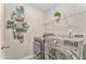 Functional laundry room equipped with modern washer and dryer, shelving, and stylish decor for efficient chores at 1302 Gardenia Ct, Villa Rica, GA 30180