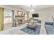 Bright living room featuring stone fireplace, plush seating, and elegant chandelier at 1302 Gardenia Ct, Villa Rica, GA 30180