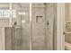Shower with glass doors and gray tiling at 1302 Gardenia Ct, Villa Rica, GA 30180