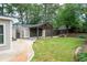 A beautiful backyard with a covered parking area and a well-maintained lawn surrounded by lush greenery at 2356 Pinkney Dr, Marietta, GA 30062