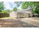 A spacious backyard with an attached garage, a driveway, and a fenced perimeter at 2356 Pinkney Dr, Marietta, GA 30062