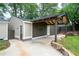 The backyard features a covered parking area with a well-manicured lawn and rock accents at 2356 Pinkney Dr, Marietta, GA 30062