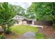 A scenic backyard features lush grass, a covered parking area, and privacy fencing at 2356 Pinkney Dr, Marietta, GA 30062