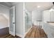 This bathroom showcases a glass-enclosed shower, sleek white cabinetry, and wood-look tile flooring at 2356 Pinkney Dr, Marietta, GA 30062