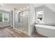 Bathroom featuring a glass shower, soaking tub, and tiled walls at 2356 Pinkney Dr, Marietta, GA 30062