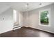A cozy bedroom with a large window, offering natural light, and dark wood floors at 2356 Pinkney Dr, Marietta, GA 30062