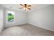 Neutral carpeted bedroom with a ceiling fan and natural light from a window at 2356 Pinkney Dr, Marietta, GA 30062