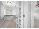 Walk-in closet with built-in shelves, carpet, and french doors at 2356 Pinkney Dr, Marietta, GA 30062