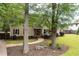 This house features a traditional-style with lush landscaping, mature trees, and a curved stone walkway at 2356 Pinkney Dr, Marietta, GA 30062