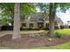 Traditional-style home with manicured lawn, mature trees, and a stone walkway at 2356 Pinkney Dr, Marietta, GA 30062