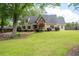 Beautiful home showcases a spacious front yard with mature trees, enhancing curb appeal at 2356 Pinkney Dr, Marietta, GA 30062