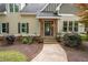 The front porch has brick and wood detailing, complemented by potted plants and flowers at 2356 Pinkney Dr, Marietta, GA 30062