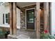 Charming entryway features a brick and wood porch with stone flooring and a modern door at 2356 Pinkney Dr, Marietta, GA 30062