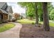 A well-manicured front yard leads to the charming entrance, framed by mature trees at 2356 Pinkney Dr, Marietta, GA 30062