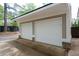 Attached two-car garage with paneled doors and brick accents on the building's foundation at 2356 Pinkney Dr, Marietta, GA 30062
