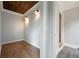 Hallway with wood-look tile, wood ceiling, and neutral paint at 2356 Pinkney Dr, Marietta, GA 30062