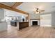 Open-concept living space features wood floors, exposed beams, a fireplace, and views of the kitchen at 2356 Pinkney Dr, Marietta, GA 30062