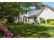Large green backyard with patio and mature trees, featuring classic home exterior at 1000 N Harbor Ct, Atlanta, GA 30328