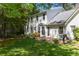 Beautiful backyard with brick patio, grill, manicured lawn, and mature trees at 1000 N Harbor Ct, Atlanta, GA 30328