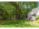 Spacious backyard with lush green lawn, mature trees and a patio area at 1000 N Harbor Ct, Atlanta, GA 30328