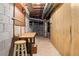 Unfinished basement with cinder block walls, exposed pipes and ceiling, and utility table at 1000 N Harbor Ct, Atlanta, GA 30328