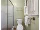Well-lit bathroom featuring a glass door shower and shuttered window at 1000 N Harbor Ct, Atlanta, GA 30328
