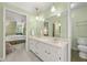 Bright bathroom with double vanity with view into attached bedroom at 1000 N Harbor Ct, Atlanta, GA 30328
