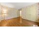 Bedroom with hardwood floors, floral wallpaper, and ample closet space at 1000 N Harbor Ct, Atlanta, GA 30328