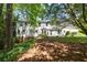 Traditional home with white siding and large yard, set among mature trees at 1000 N Harbor Ct, Atlanta, GA 30328