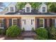 Beautiful brick home with dormer windows, black shutters, and a charming white front door at 1000 N Harbor Ct, Atlanta, GA 30328
