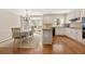 Open kitchen and breakfast nook with white cabinets, granite counters, and bay windows at 1000 N Harbor Ct, Atlanta, GA 30328