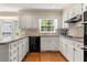 Well-lit kitchen featuring white cabinetry, modern appliances, and a breakfast bar at 1000 N Harbor Ct, Atlanta, GA 30328