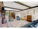 Open living room with brick fireplace, exposed beams, and doorway to breakfast area at 1000 N Harbor Ct, Atlanta, GA 30328