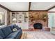 Bright living room with brick fireplace, built-in shelves, and exposed beams at 1000 N Harbor Ct, Atlanta, GA 30328