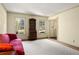 Bright living room with white carpet, large windows, and a red plush sofa at 1000 N Harbor Ct, Atlanta, GA 30328