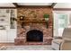 Cozy living room featuring a brick fireplace, built-in bookshelves, and charming interior design at 1000 N Harbor Ct, Atlanta, GA 30328