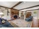 Inviting living room with brick fireplace, exposed beams, and built-in bookshelves at 1000 N Harbor Ct, Atlanta, GA 30328