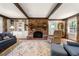 Bright living room with brick fireplace, built-in shelves, and exposed beams at 1000 N Harbor Ct, Atlanta, GA 30328