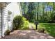 Cozy brick patio area with grill overlooking expansive backyard with surrounding trees at 1000 N Harbor Ct, Atlanta, GA 30328