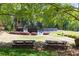 Community picnic area with tables overlooking tennis courts and lush landscaping at 1000 N Harbor Ct, Atlanta, GA 30328