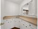 Charming sink area featuring white cabinets, faucet, and window with shutters at 1000 N Harbor Ct, Atlanta, GA 30328