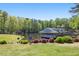 Scenic view of lakefront with dock and serene backdrop of tall trees at 1000 N Harbor Ct, Atlanta, GA 30328