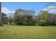 Grassy backyard with mature trees and landscaping near the house's screened-in porch at 105 Blackberry Ct, Woodstock, GA 30188