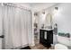 Quirky bathroom with modern black vanity and decor, complemented by patterned shower curtain at 105 Blackberry Ct, Woodstock, GA 30188