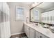 Bright bathroom featuring a double vanity with drawers and a large framed mirror at 105 Blackberry Ct, Woodstock, GA 30188