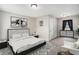 Bright bedroom with neutral walls, carpeted floors, large bed, and matching dresser at 105 Blackberry Ct, Woodstock, GA 30188