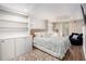 Stylish bedroom featuring custom built-ins, tray ceiling, and a doorway to the outside at 105 Blackberry Ct, Woodstock, GA 30188