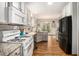 Spacious kitchen with white cabinets, granite countertops, stainless steel appliances, and hardwood floors at 105 Blackberry Ct, Woodstock, GA 30188